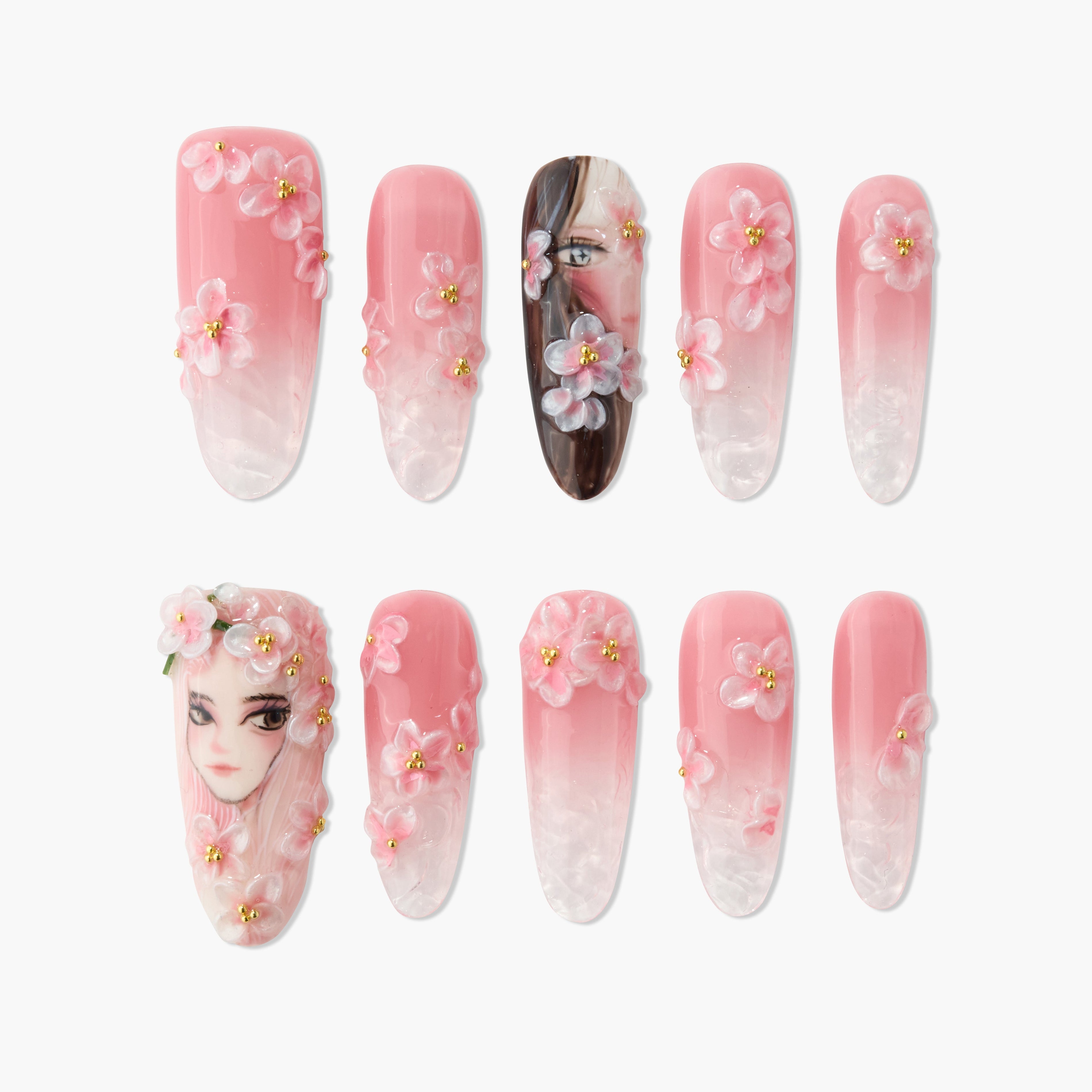 Handmade pink press-on nails with 3D floral designs and painted faces, ombre finish