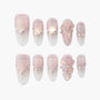 Handmade pink and white press-on nails with rhinestone accents and 3D floral design