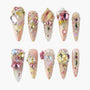Handmade press-on nails with pink, gold, and crystal 3D gemstones and floral accents