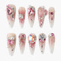 Handmade press-on nails with pink ombre, rhinestones, pearls, and 3D floral accents.