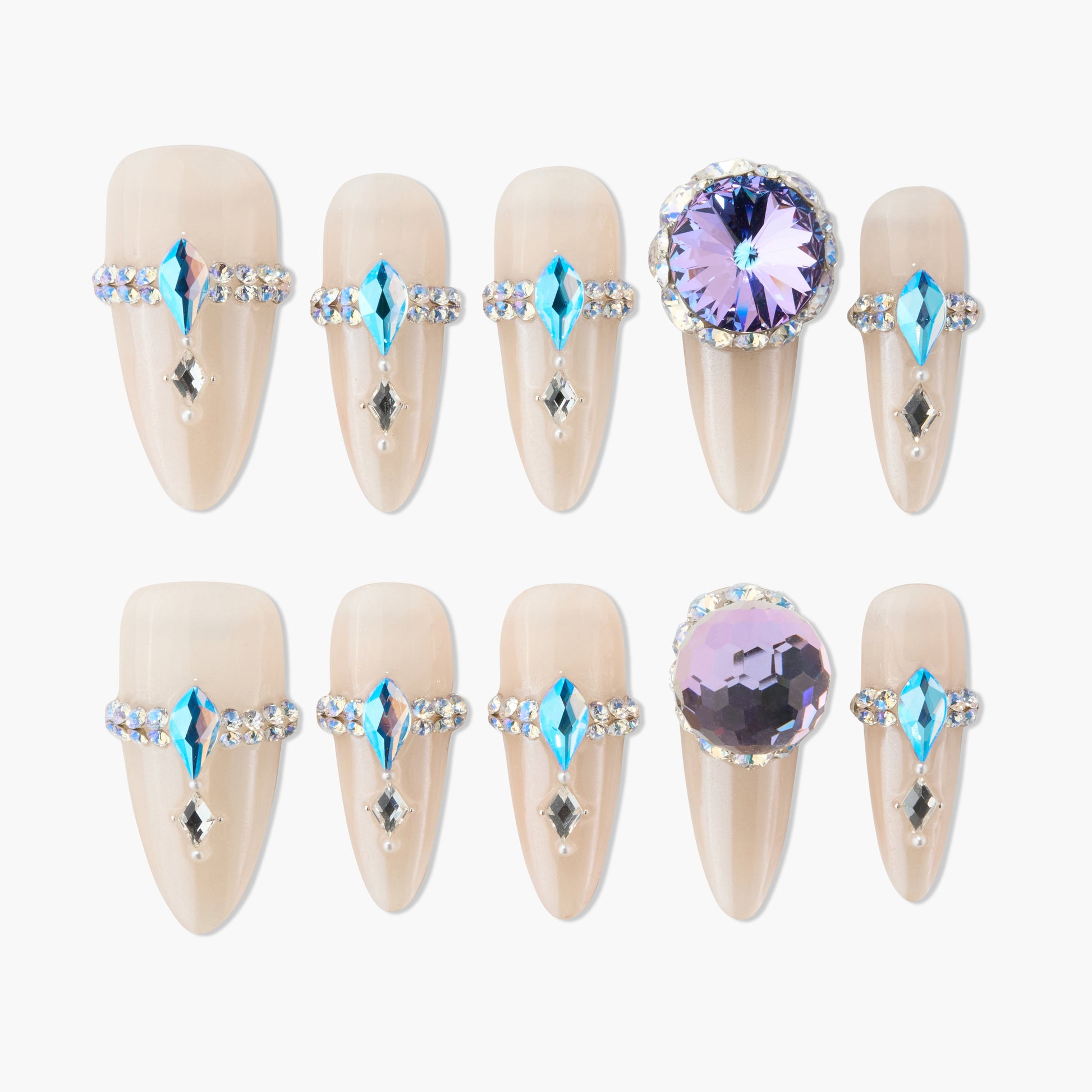 Handmade press-on nails with nude base, blue and crystal rhinestone accents, large purple gems