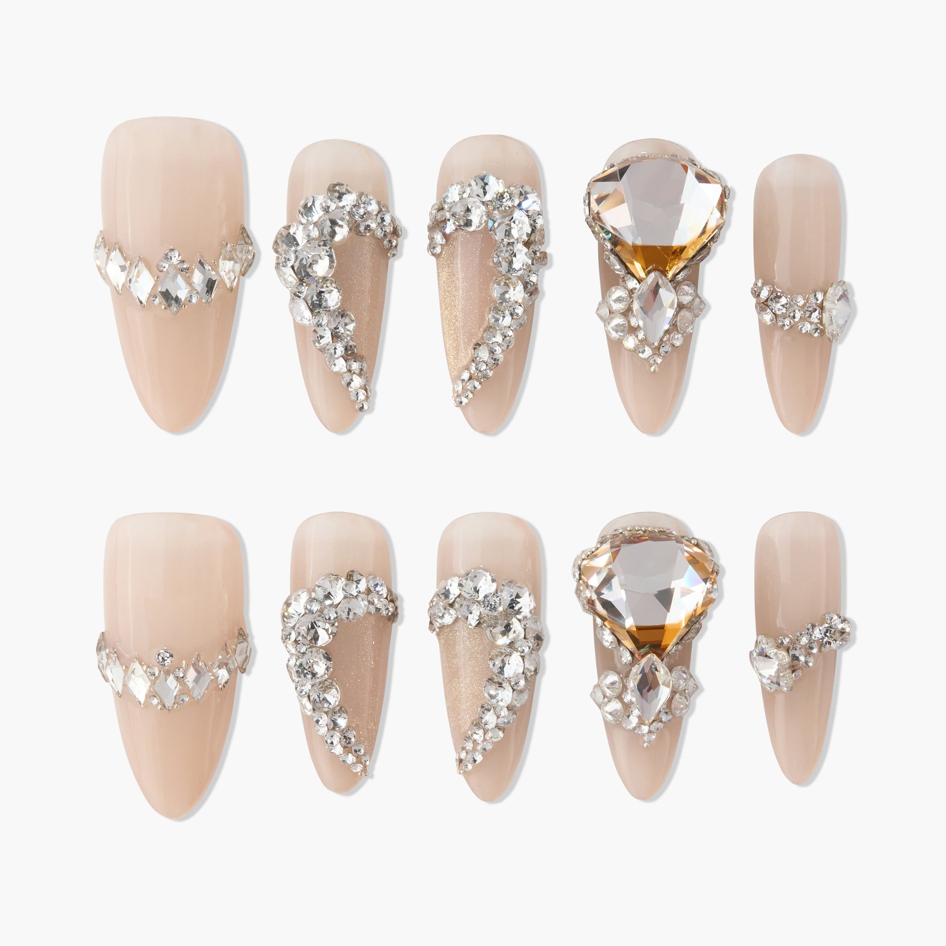 Nude press-on nails with 3D rhinestones and large crystal heart accents, elegant nail design