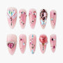 Pink press-on nails with 3D heart gems, rhinestones, and butterfly decorations.
