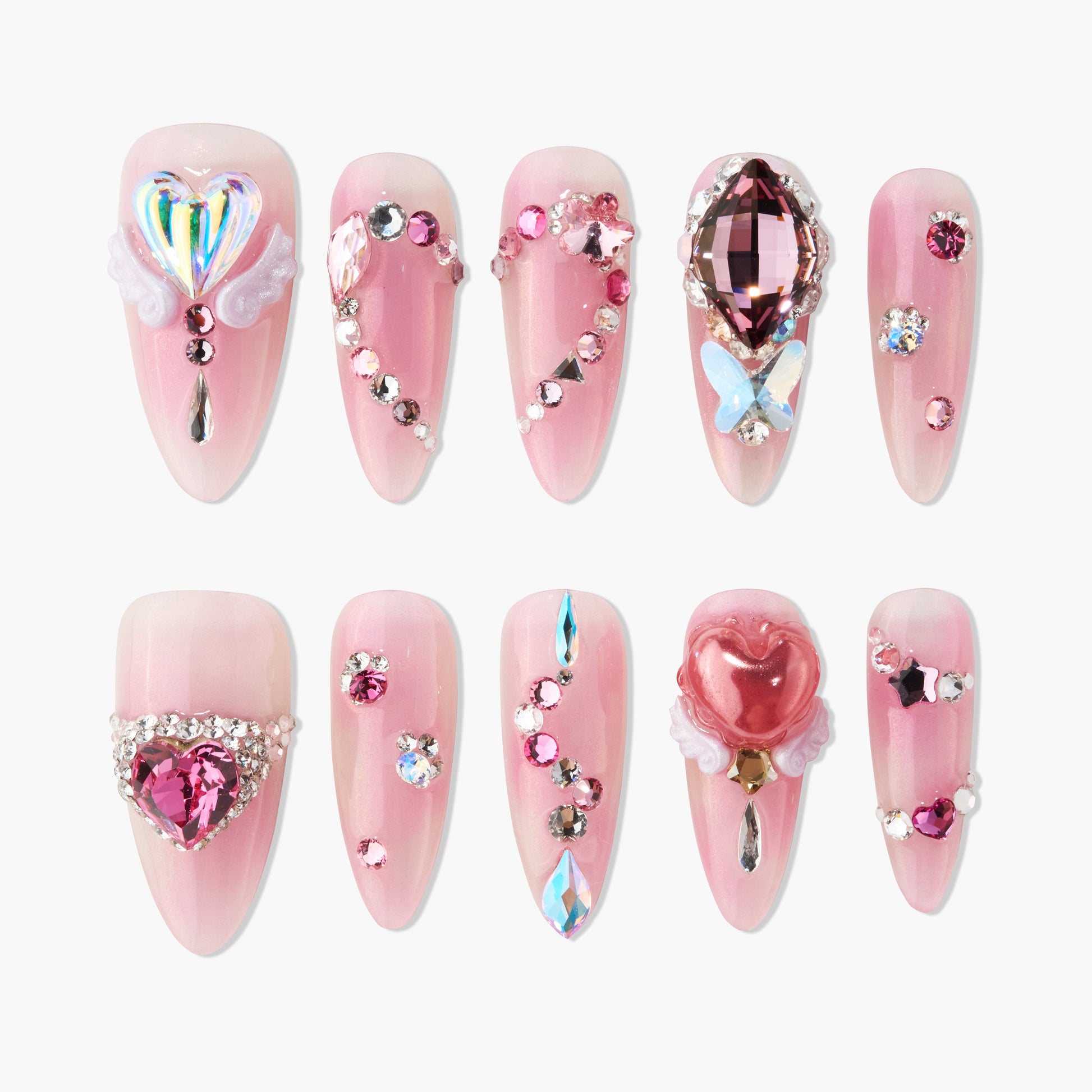 Pink press-on nails with 3D heart gems, rhinestones, and butterfly decorations.