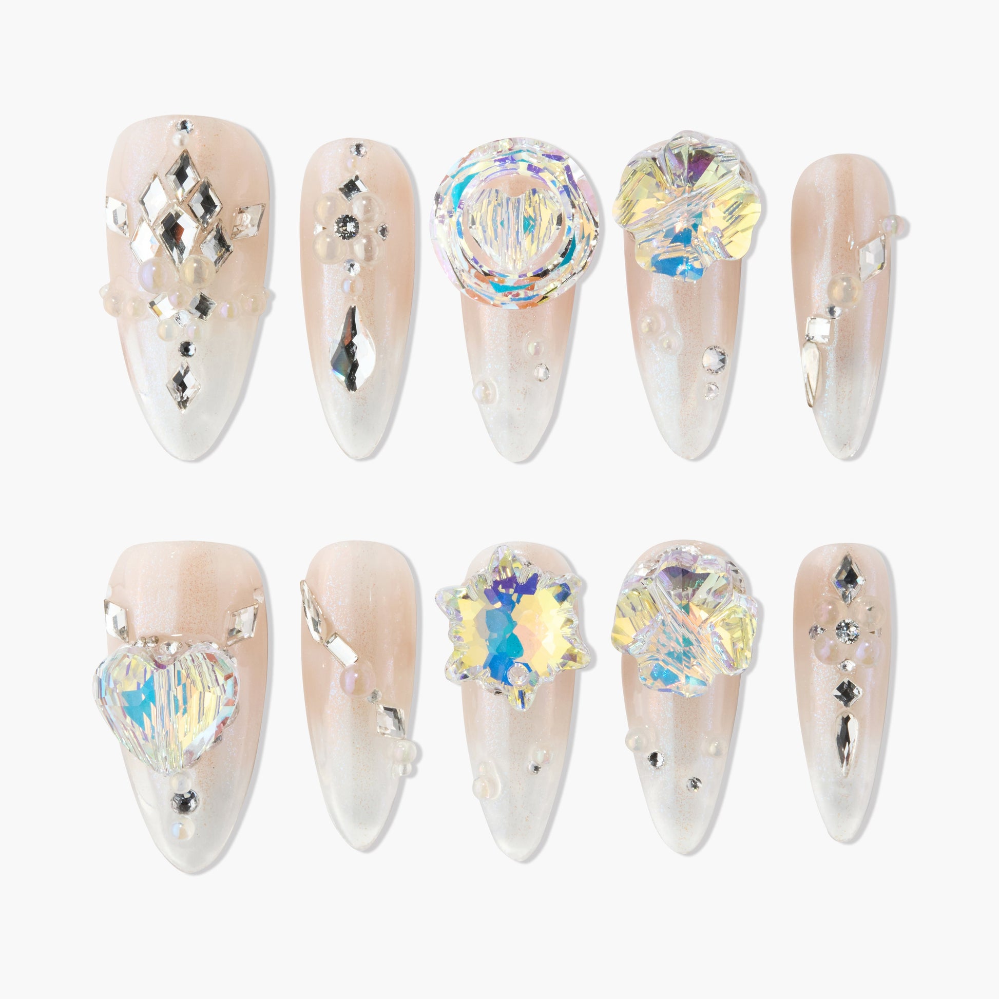 Long almond-shaped press-on nails with nude ombré base, rhinestones, 3D crystal accents, and pearl details