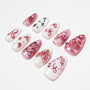 Handmade press-on nails with pink and white 3D butterfly and bow designs, rhinestones, pearls