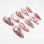 Handmade pink press-on nails with pearls, rhinestones, and glitter butterfly designs