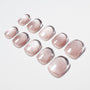 Set of pink glitter press-on nails with a glossy finish arranged on a white background