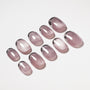 Set of glossy mauve ombre press-on nails with a subtle shimmer on a white background