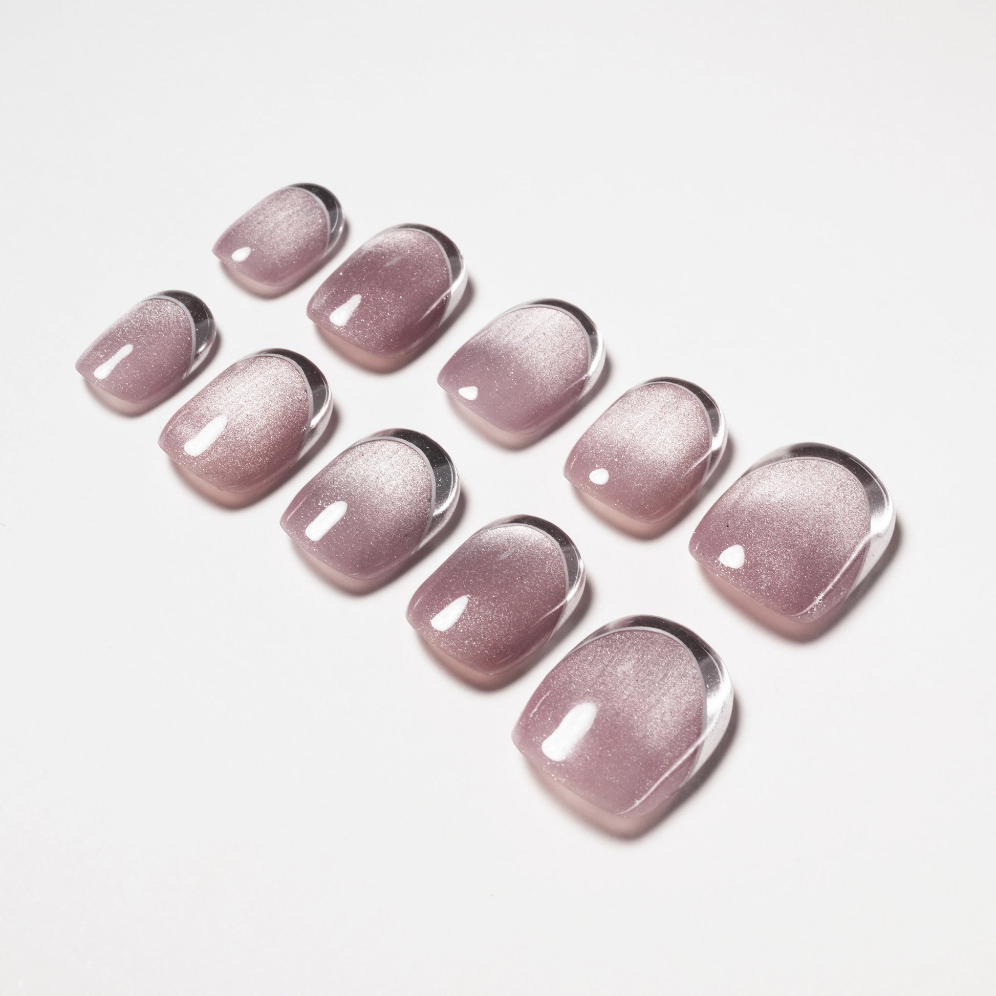 Glossy mauve handmade press-on nails with a shimmer finish, neatly arranged on white