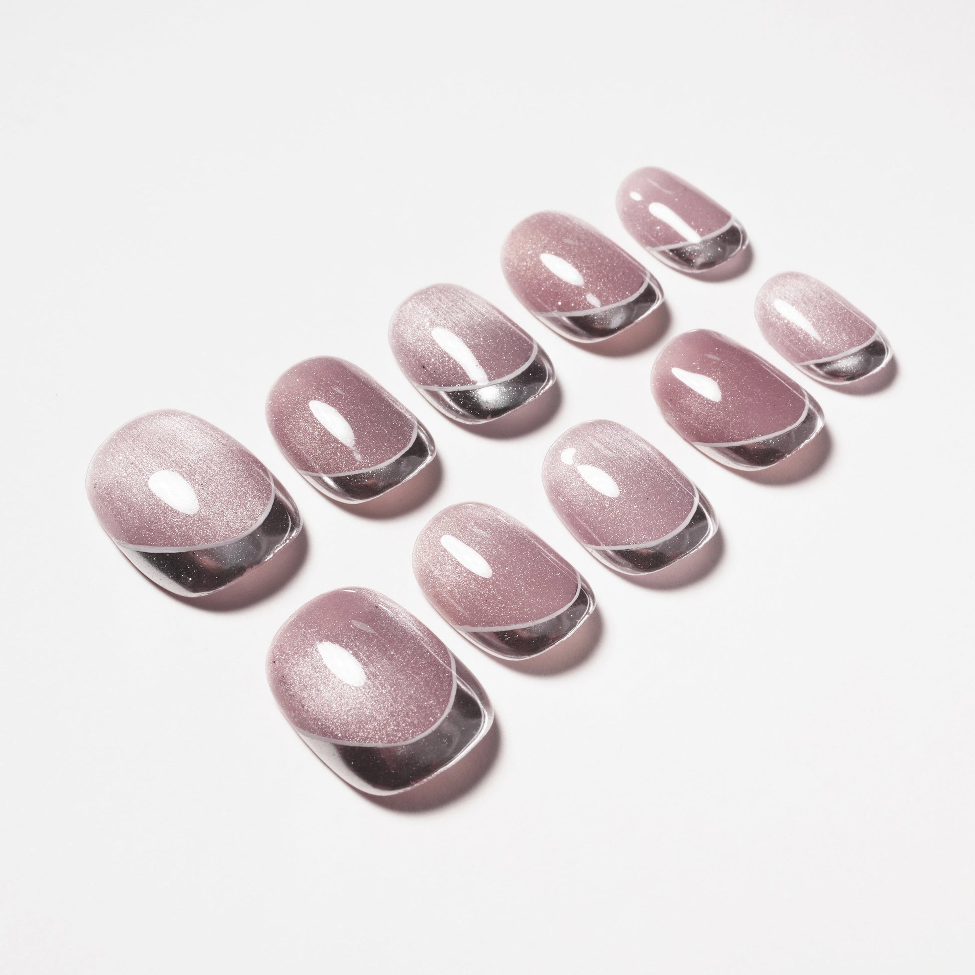 Set of glossy mauve press-on nails with silver tips on a white background