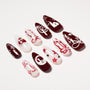 Handmade press-on nails with red and white abstract designs, pearls, and rhinestone accents