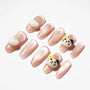 Pink press-on nails with glossy finish, 3D heart and cat face nail art accents.