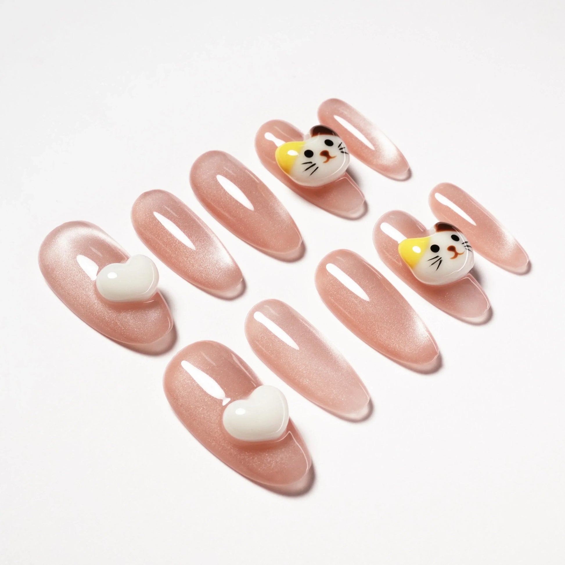 Pink press-on nails with glossy finish, decorated with 3D cat faces and white hearts