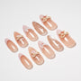 Handmade press-on nails in nude pink with 3D bows and playful polka dot designs