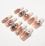Handmade press-on nails in nude ombre with large rhinestone and crystal embellishments
