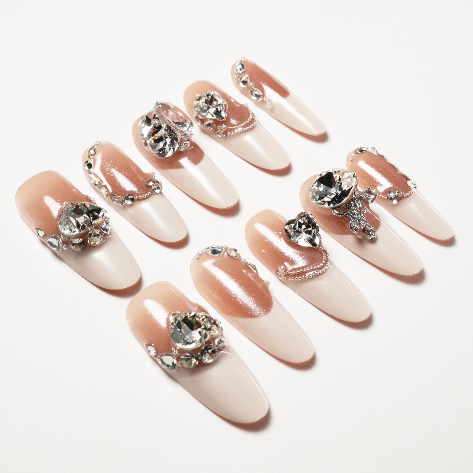 Pink and nude ombre press-on nails with large rhinestones and pearl 3D accents