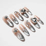 Handmade ombre press-on nails with silver gradient and large rhinestone accents