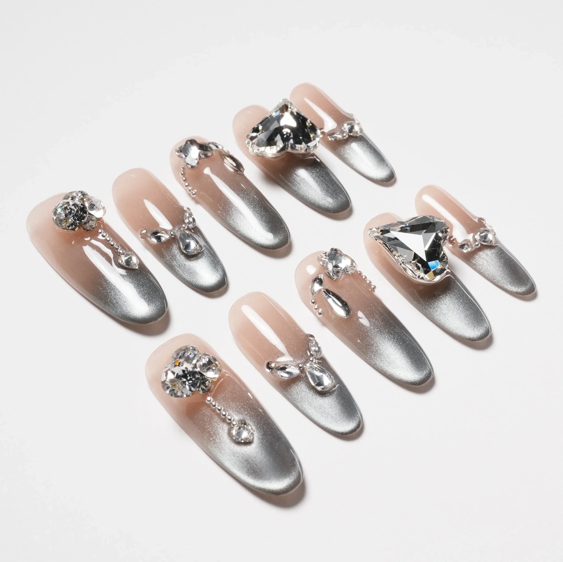 Handmade ombre press-on nails with silver gradient and large rhinestone accents