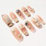 Cute press-on nails with 3D teddy bear, bows, pearls, and heart-shaped rhinestone accents