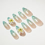 Handmade press-on nails in nude and teal ombre with glitter and 3D floral accents