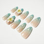 Handmade press-on nails in blue ombre with glitter and 3D floral accents