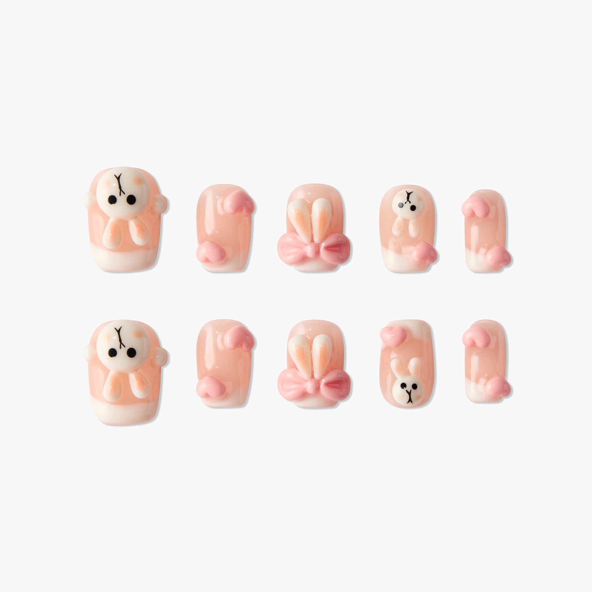 Handmade press-on nails with 3D pink bunny and heart designs on a nude base.
