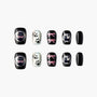 Handmade press-on nails with black cat, paw prints, pink bows, and glitter accents