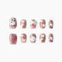 Cute pink handmade press-on nails with cat, bows, hearts, and glittery finish