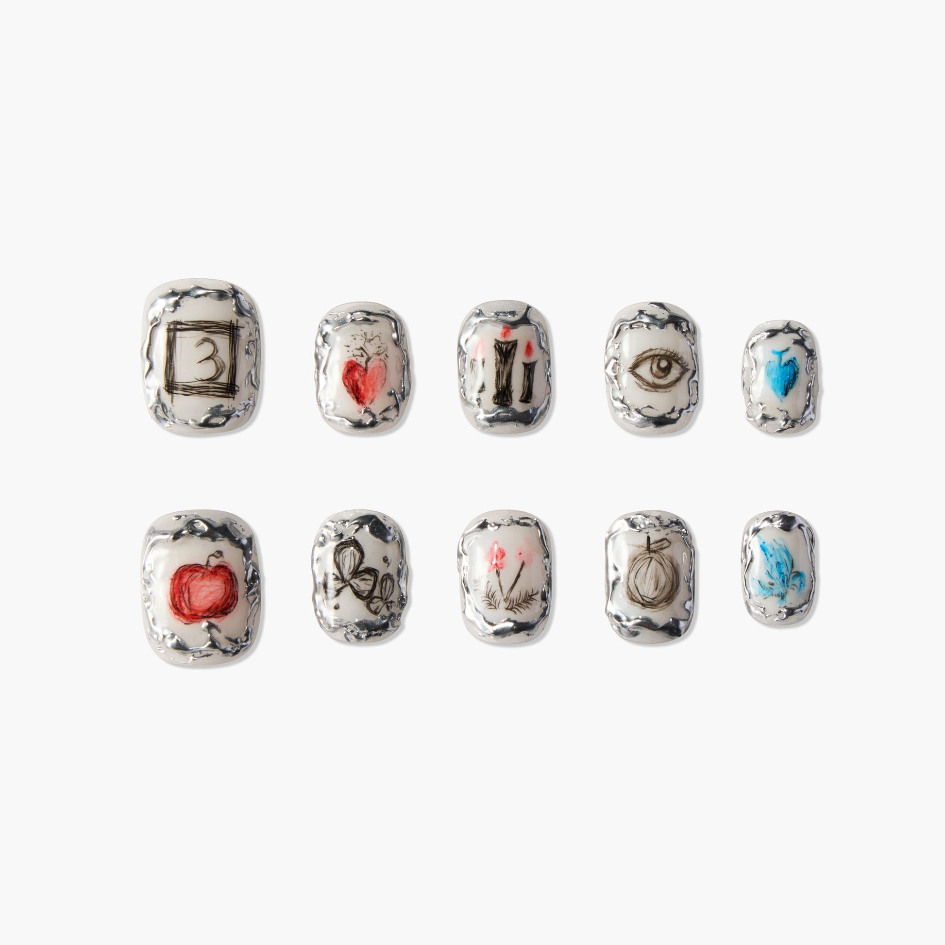 Handmade press-on nails with silver borders and unique art designs including hearts, eyes, and symbols.