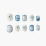Set of handmade press-on nails in white and blue marble with bow and pearl accents