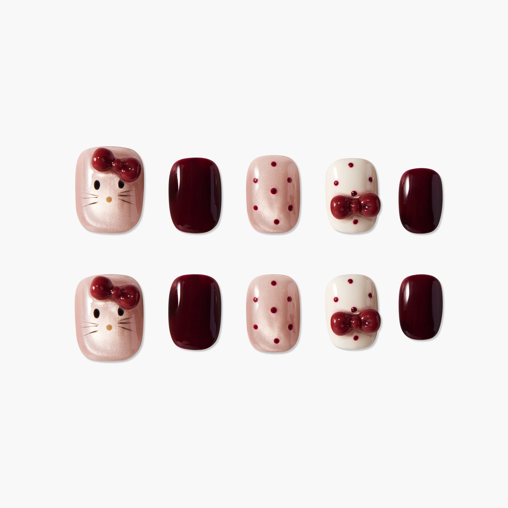 Handmade press-on nails with maroon, polka dot, and cat face designs, glossy finish.