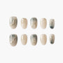 Handmade press-on nails with neutral beige and grey marble design and gold accents