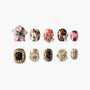 Handmade press-on nails with 3D floral, gold, and glitter designs on a white background.