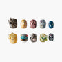 Handmade press-on nails with 3D floral, pearl, butterfly, and gem designs on various colors.