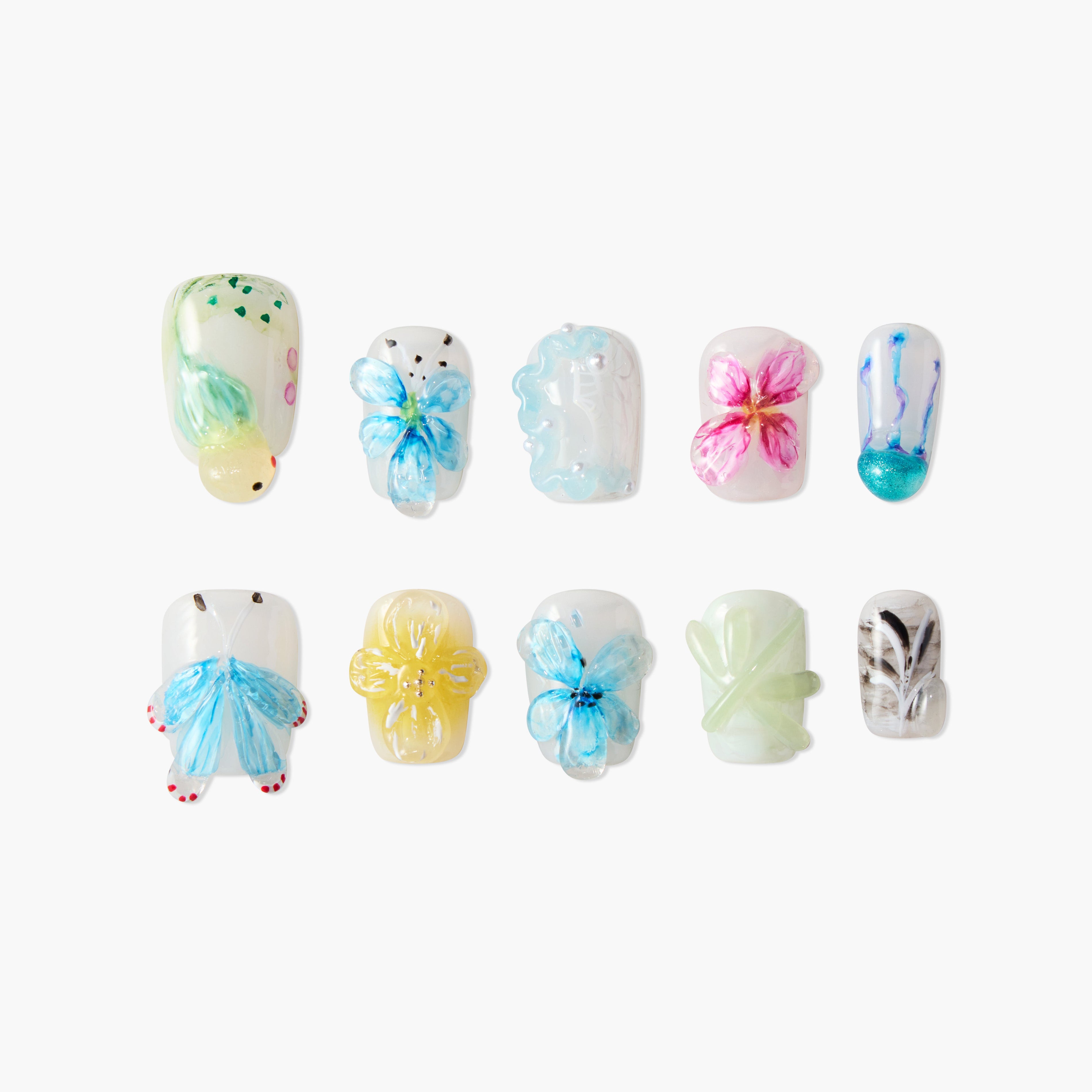 Handmade press-on nails with colorful 3D butterfly and floral designs on a white background