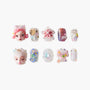 Handmade press-on nails with 3D designs, colorful gems, floral and face art accents on white background.