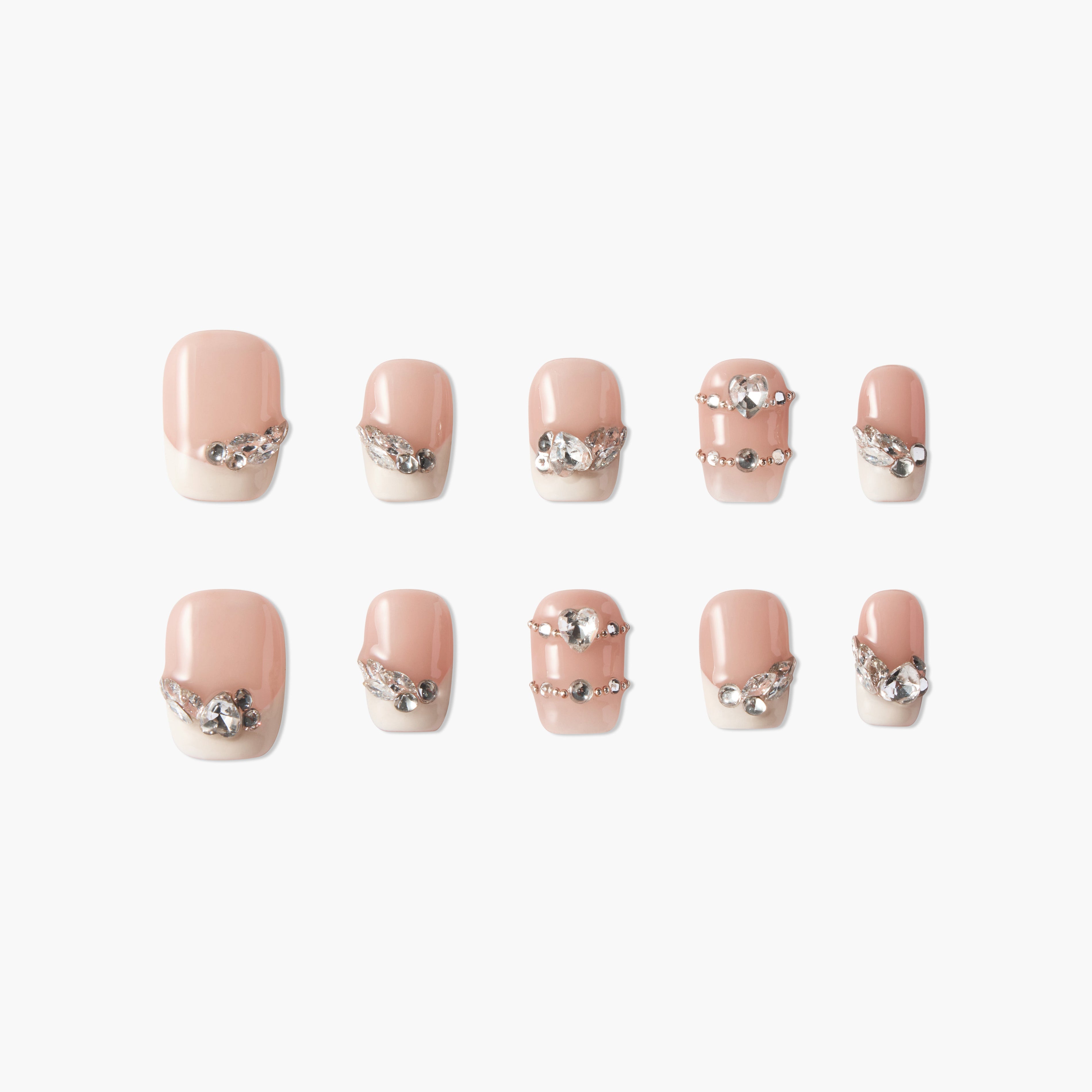 Handmade press-on nails with nude base, pearl tips, and silver rhinestone accents