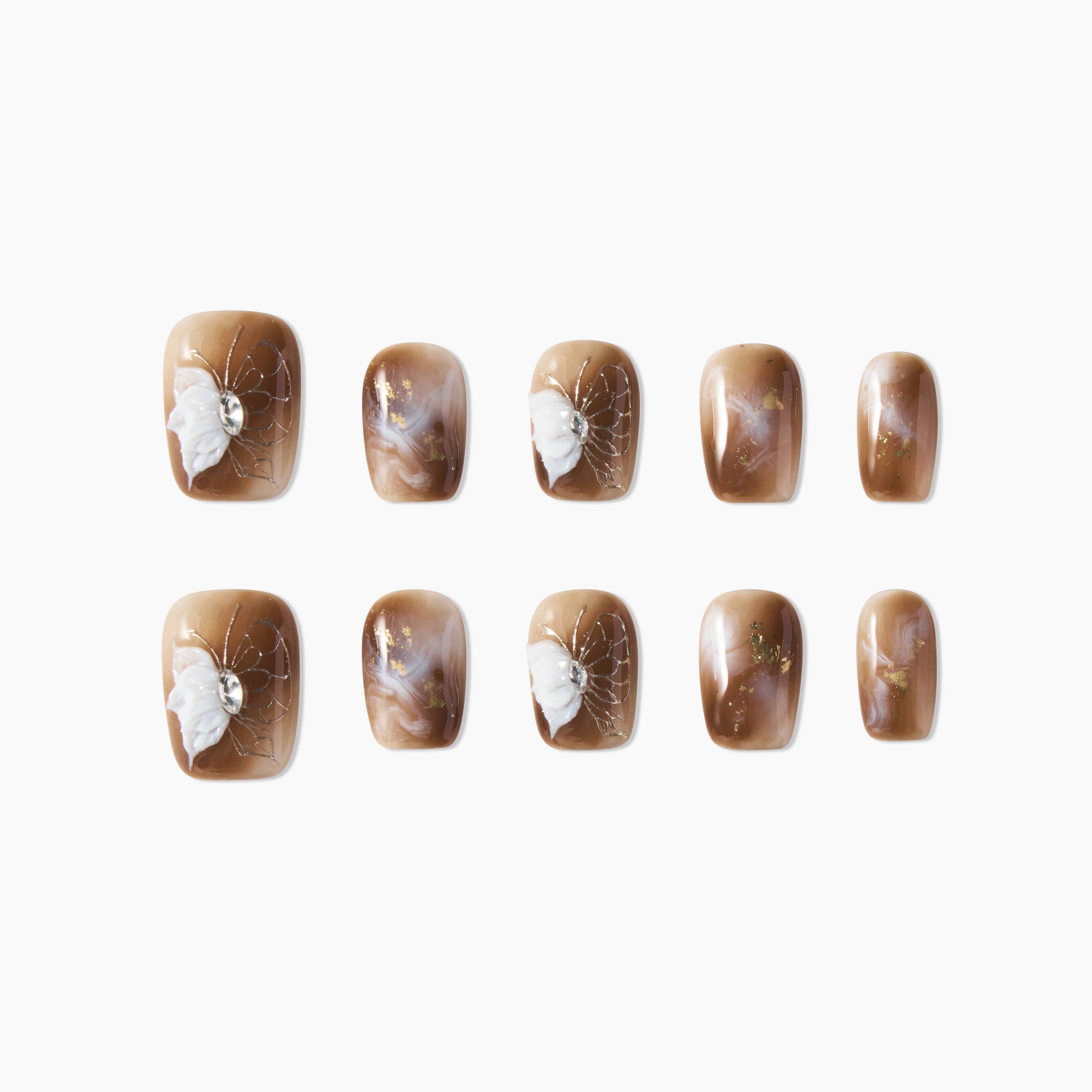Brown marble press-on nails with white 3D butterfly and crystal accents, glossy finish