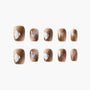 Brown marble press-on nails with white 3D butterfly and crystal accents, glossy finish