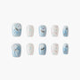 Blue and white press-on nails with jellyfish designs, glitter, and rhinestone accents