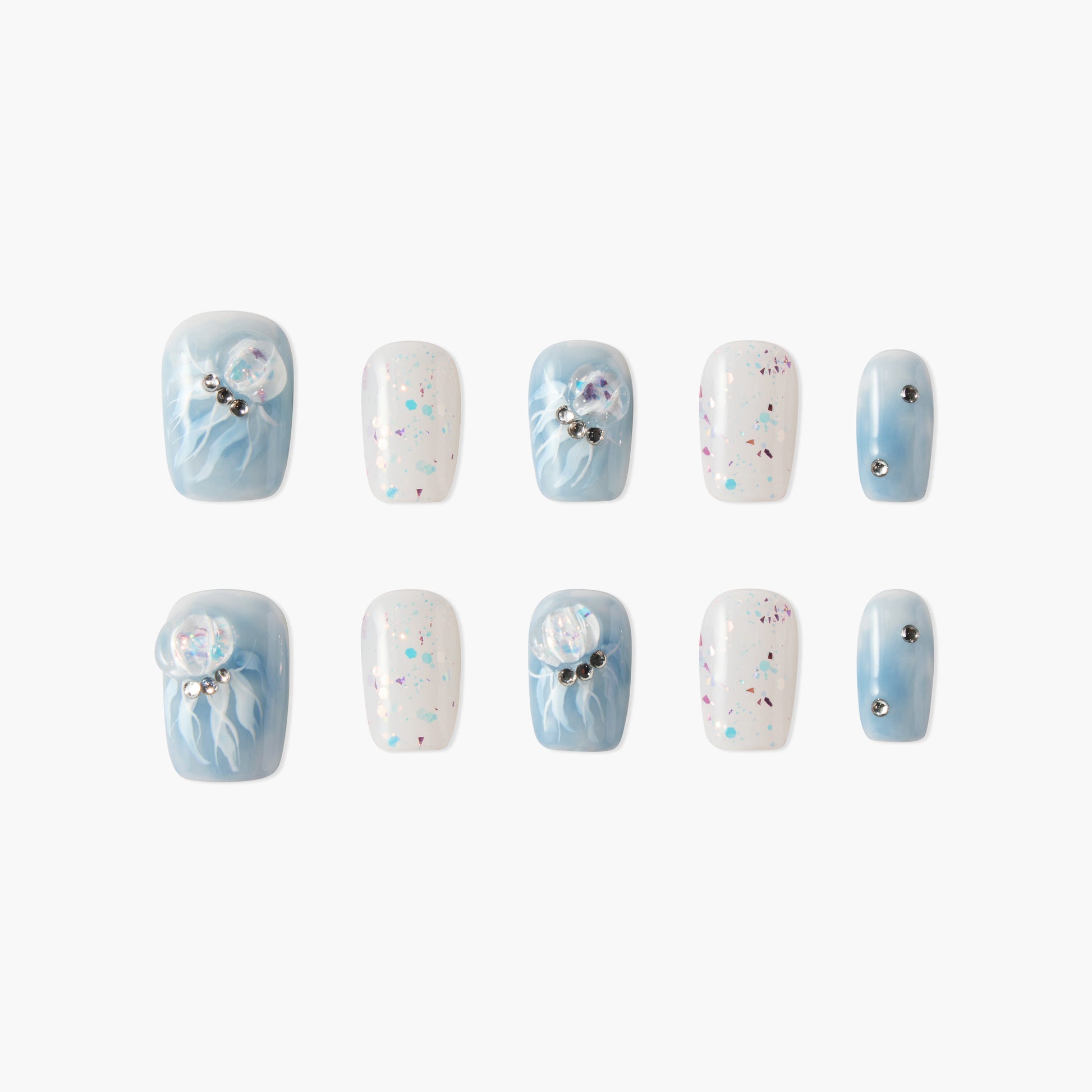 Blue and white press-on nails with jellyfish designs, glitter, and rhinestone accents