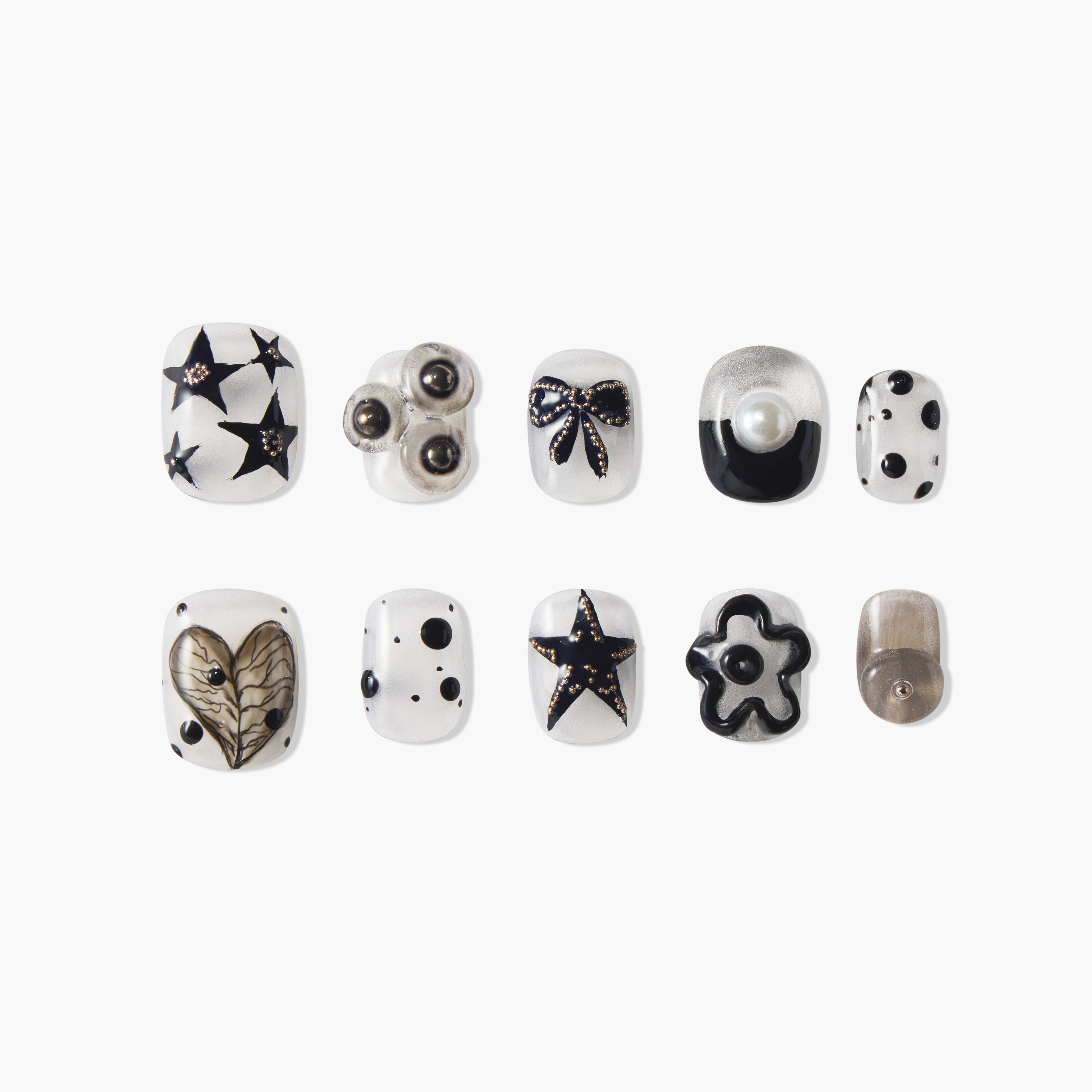 Handmade press-on nails with black star, heart, bow, pearl, polka dot, and flower designs