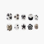 Handmade press-on nails with black star, heart, bow, pearl, polka dot, and flower designs