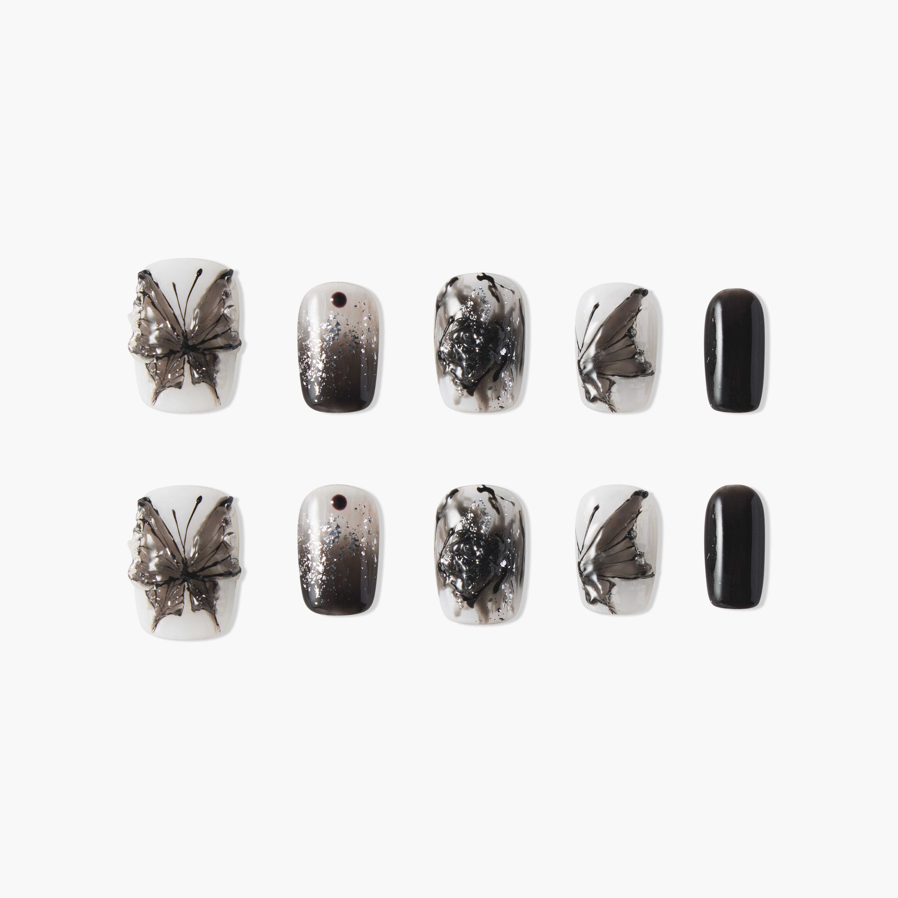 Black and white butterfly press-on nails with ombre, glitter, and abstract designs