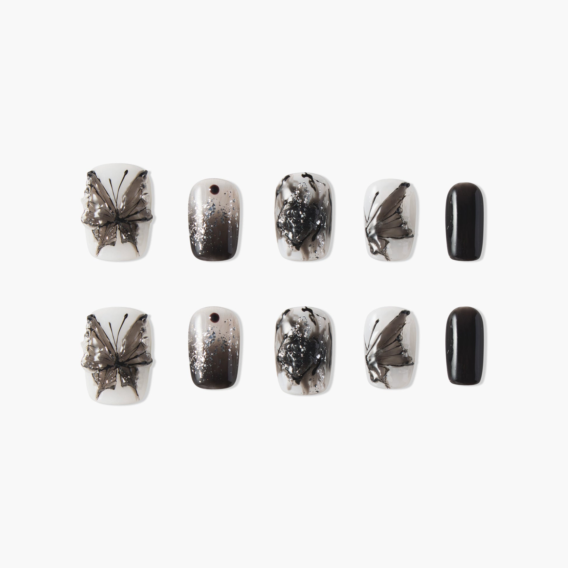 Black and white butterfly press-on nails with ombre, glitter, and abstract designs