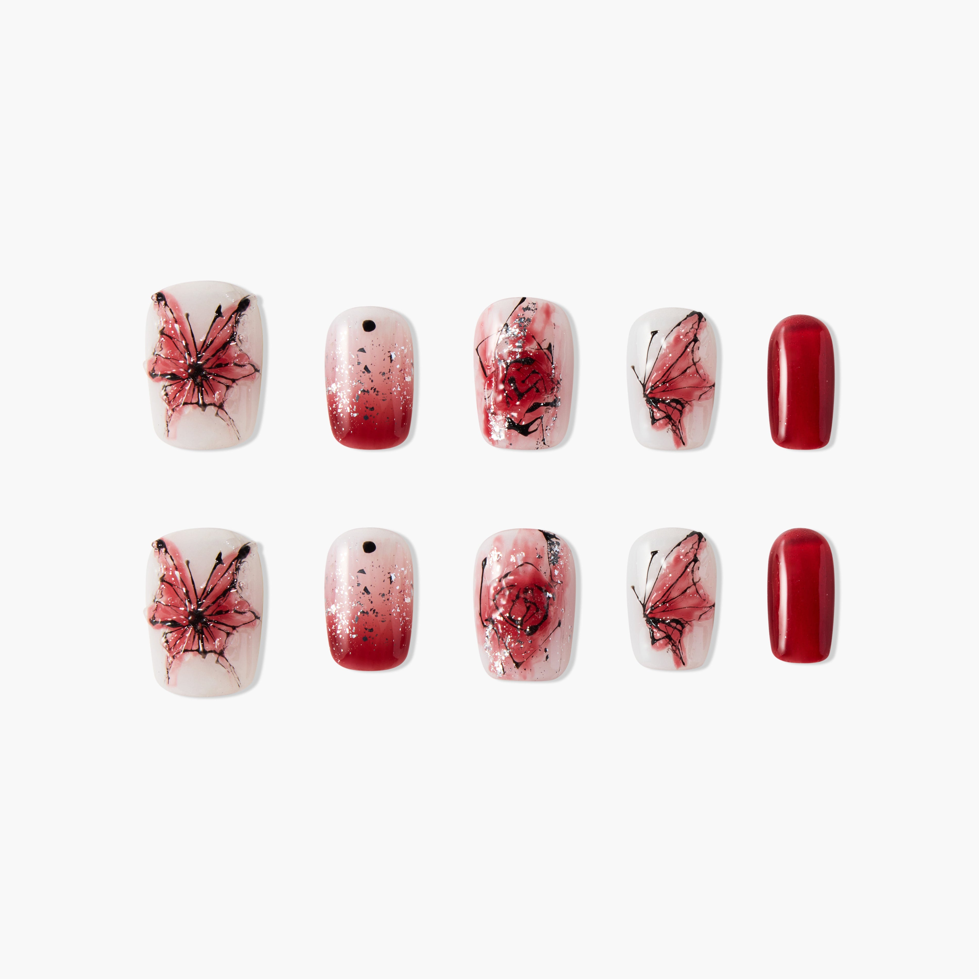 Red and white press-on nails with butterfly, rose, glitter, ombre, and solid designs.