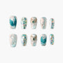 Handmade press-on nails with pearl, teal 3D accents and glitter, iridescent ocean-inspired design