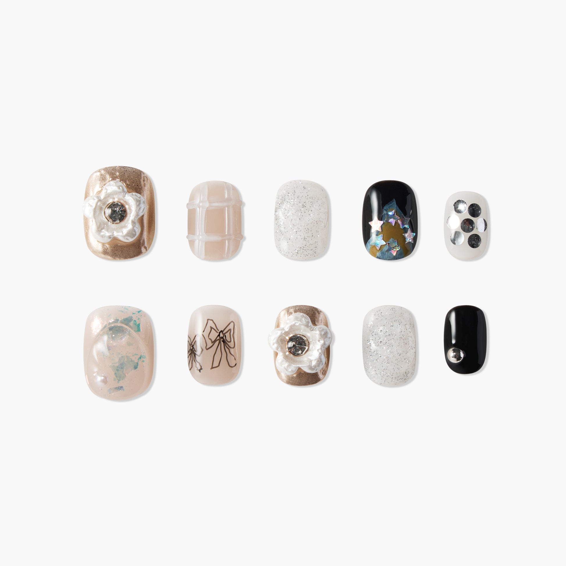 Set of handmade press-on nails with metallic, glitter, floral, and star designs on a white background
