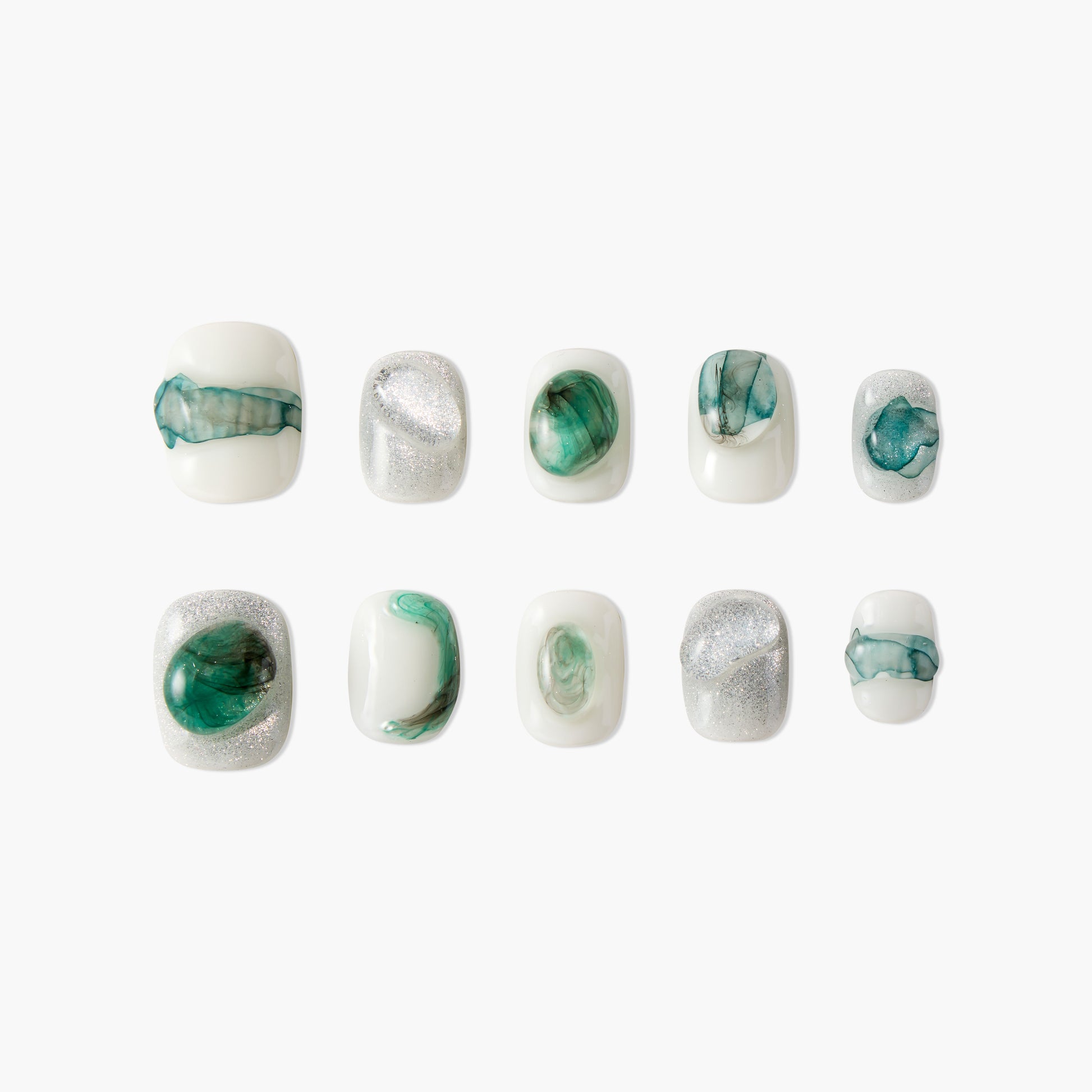Handmade press-on nails in white with green marble and silver glitter designs, laid out on white background.